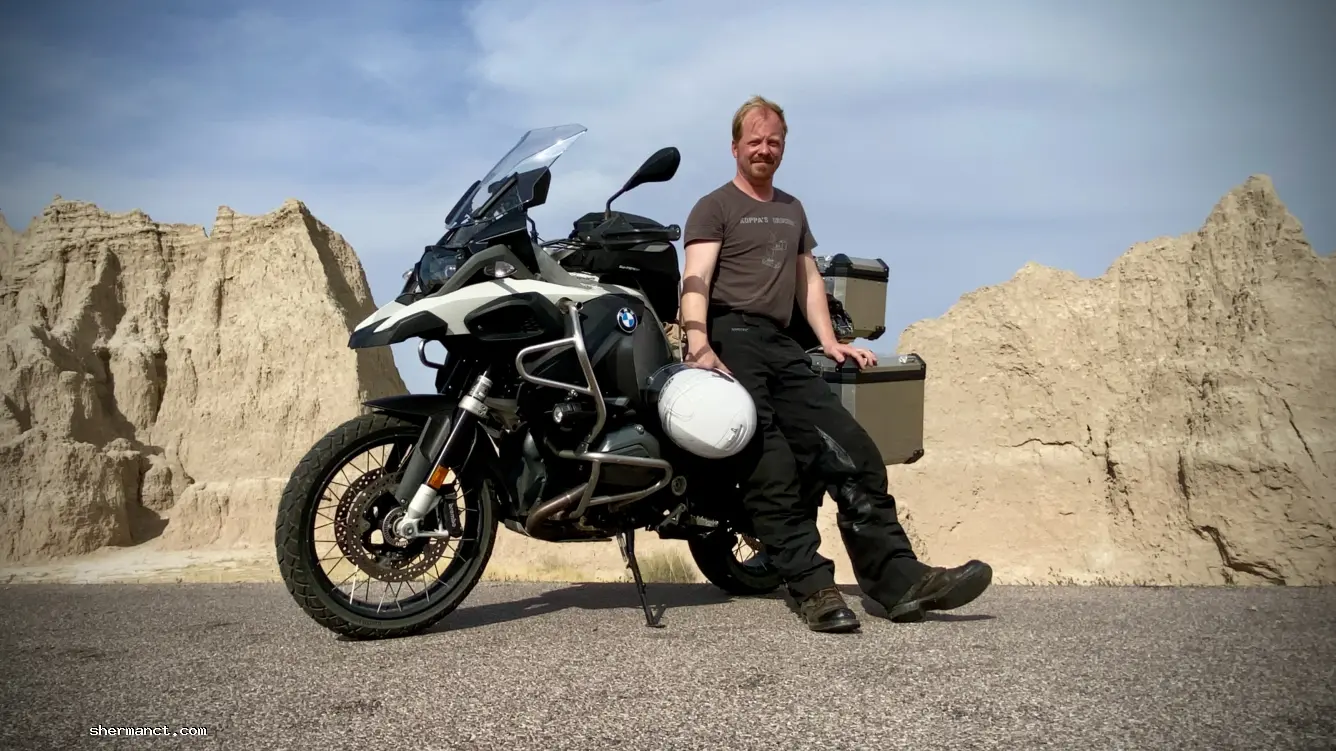<strong>The Ultimate Test Group:</strong> The author pauses during a 3,000-mile cross-country camping ride. Survival on the open road isn't built on parking-lot mythology; it is governed strictly by tire compounds, forward momentum, and the unforgiving laws of physics.